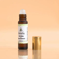 Amalia prickly pear anti-wrinkle Roll-on bottle with gold cap on a beige background