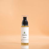 Bottle of Amalia Aroma 5 massage oil on a peach background