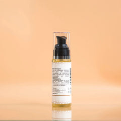 Skincare bottle with pump on a peach background