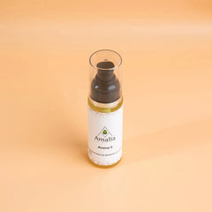 Amalia hair product bottle on a beige background