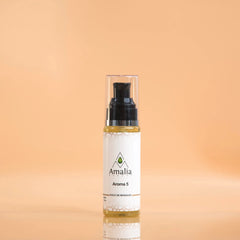 Bottle of Amalia Aroma 5 massage oil on a peach background
